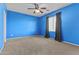 Spacious bedroom features a ceiling fan, neutral carpet, and large windows allowing for natural light and ventilation at 21337 E Waverly Dr, Queen Creek, AZ 85142