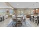 Bright dining area with seating for eight, view to the backyard pool, and open to the spacious living room at 21337 E Waverly Dr, Queen Creek, AZ 85142