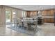 Open dining area features seating for eight, with a view of the outdoor pool and a kitchen with tile backsplash at 21337 E Waverly Dr, Queen Creek, AZ 85142