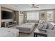 Relaxing living room features a large sectional sofa, a flat-screen TV, and neutral tones, creating a cozy atmosphere at 21337 E Waverly Dr, Queen Creek, AZ 85142