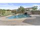 Beautiful backyard pool features a waterfall feature, lush landscaping, and ample space to relax at 21337 E Waverly Dr, Queen Creek, AZ 85142