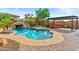 Backyard pool with rock waterfall, slide and hot tub, set in lush landscaping, perfect for outdoor entertaining at 21337 E Waverly Dr, Queen Creek, AZ 85142