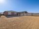 Exterior view of the house and backyard with a low brick wall surround at 22502 W Tonopah Dr, Surprise, AZ 85387