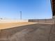 Large, undeveloped backyard featuring dirt and a tall brick wall at 22502 W Tonopah Dr, Surprise, AZ 85387