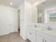 Bathroom featuring double sinks, tile floors, and linen closet at 22502 W Tonopah Dr, Surprise, AZ 85387