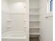 Clean bathroom with a tub-shower combination and built-in shelving for storage at 22502 W Tonopah Dr, Surprise, AZ 85387