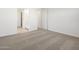 Neutral carpeted bedroom with white walls and two entry points to other rooms at 22502 W Tonopah Dr, Surprise, AZ 85387