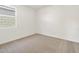 Bedroom with neutral carpet, white walls, and a window with blinds at 22502 W Tonopah Dr, Surprise, AZ 85387
