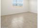 Bright bedroom with neutral tile flooring and large window, offering natural light at 22502 W Tonopah Dr, Surprise, AZ 85387