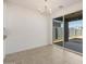Bright dining area features neutral tiling and sliding glass doors to an outdoor space at 22502 W Tonopah Dr, Surprise, AZ 85387