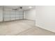 Spacious two car garage with concrete floor and a white garage door at 22502 W Tonopah Dr, Surprise, AZ 85387