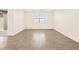 Bright living room featuring tile floors and a large window for natural light at 22502 W Tonopah Dr, Surprise, AZ 85387