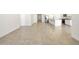 Spacious living area featuring tile flooring and a view into the modern kitchen at 22502 W Tonopah Dr, Surprise, AZ 85387