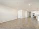 Large, open living space with tile flooring, leading to kitchen and other rooms at 22502 W Tonopah Dr, Surprise, AZ 85387