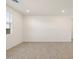 Spacious living area with light-colored tile flooring and a large window at 22502 W Tonopah Dr, Surprise, AZ 85387