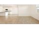 Open-concept living area featuring modern tile flooring, connected to kitchen and dining at 22502 W Tonopah Dr, Surprise, AZ 85387