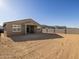 View of the backyard featuring the home's exterior and cinder block wall for added privacy at 22514 W Tonopah Dr, Surprise, AZ 85387