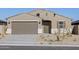 Charming single-story home featuring desert landscaping, a two-car garage and a welcoming front entry at 22514 W Tonopah Dr, Surprise, AZ 85387