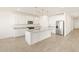 Bright kitchen features white cabinets, granite countertops, stainless steel appliances, and a spacious center island at 22514 W Tonopah Dr, Surprise, AZ 85387