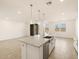 Open-concept kitchen with a large island, pendant lighting, stainless steel appliances, and tile flooring at 22514 W Tonopah Dr, Surprise, AZ 85387