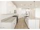 Spacious modern kitchen with white cabinets, granite counters, stainless appliances, and an island with seating at 22514 W Tonopah Dr, Surprise, AZ 85387