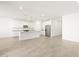Bright kitchen features white cabinets, granite countertops, stainless steel appliances, and a spacious center island at 22514 W Tonopah Dr, Surprise, AZ 85387