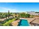 Aerial view showcasing the refreshing pool surrounded by lush greenery and neighborhood views at 2300 E Sanoque Ct, Gilbert, AZ 85298
