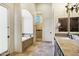 Bathroom features a soaking tub, walk-in shower, double vanity, and classic fixtures at 2300 E Sanoque Ct, Gilbert, AZ 85298