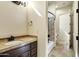 Bathroom featuring tiled backsplash, dark fixtures, framed mirror, vanity, and neutral color palette at 2300 E Sanoque Ct, Gilbert, AZ 85298
