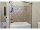 Close up of a bath tub with dark fixtures and a tiled surround at 2300 E Sanoque Ct, Gilbert, AZ 85298