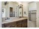 Well-lit bathroom with double vanity, tile countertops, and classic fixtures at 2300 E Sanoque Ct, Gilbert, AZ 85298