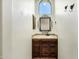 Bathroom features a dark wooden vanity and a decorative mirror at 2300 E Sanoque Ct, Gilbert, AZ 85298