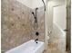 Close up of a bath tub with dark fixtures and a tiled surround at 2300 E Sanoque Ct, Gilbert, AZ 85298