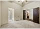 Bedroom with a ceiling fan and glimpses into an adjacent room at 2300 E Sanoque Ct, Gilbert, AZ 85298