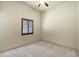 Neutral-toned bedroom with window featuring blinds, a carpeted floor, and light fixture at 2300 E Sanoque Ct, Gilbert, AZ 85298