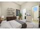 Bright bedroom with a neutral color palette and an ensuite bathroom, creating a tranquil retreat at 2300 E Sanoque Ct, Gilbert, AZ 85298