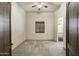 Spacious bedroom with neutral carpet, ceiling fan and a dark shuttered window at 2300 E Sanoque Ct, Gilbert, AZ 85298