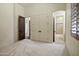 Neutral bedroom with doorways to a bathroom and closet space at 2300 E Sanoque Ct, Gilbert, AZ 85298
