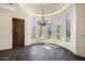 Sunlit dining nook with a chandelier and arched windows, offering scenic views at 2300 E Sanoque Ct, Gilbert, AZ 85298