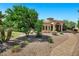 Stunning home features a grand entrance with stone columns and a beautifully landscaped front yard at 2300 E Sanoque Ct, Gilbert, AZ 85298