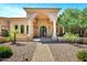 Inviting front entrance with stone accents, a covered archway, and lush landscaping at 2300 E Sanoque Ct, Gilbert, AZ 85298