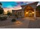 Charming front entrance showcasing stone accents, arched doorway, and a lit walkway leading to the front door at 2300 E Sanoque Ct, Gilbert, AZ 85298