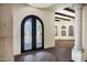 Hallway with decorative tile flooring, iron door and elegant chandelier at 2300 E Sanoque Ct, Gilbert, AZ 85298