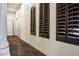 Hallway showcasing tiled floor and dark-stained window shutters at 2300 E Sanoque Ct, Gilbert, AZ 85298