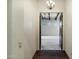 View from hallway into room with dark wooden beam ceiling, carpet, and wall art at 2300 E Sanoque Ct, Gilbert, AZ 85298