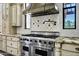 Close-up of a professional-grade stainless steel Viking stove with a custom vent hood at 2300 E Sanoque Ct, Gilbert, AZ 85298