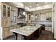 Gourmet kitchen featuring a large island, custom cabinets, and professional appliances at 2300 E Sanoque Ct, Gilbert, AZ 85298