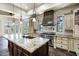 Elegant kitchen with custom cabinetry, an island with a sink, and stainless steel appliances at 2300 E Sanoque Ct, Gilbert, AZ 85298