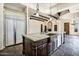 Open kitchen with a large island featuring a farmhouse sink and granite countertops, perfect for entertaining at 2300 E Sanoque Ct, Gilbert, AZ 85298