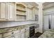 Kitchen features custom cabinetry, stainless steel appliances, granite countertops, and a wine cooler at 2300 E Sanoque Ct, Gilbert, AZ 85298